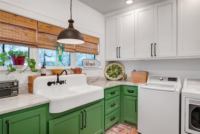 laundry room with sink, separate washer and dryer, and cabinets