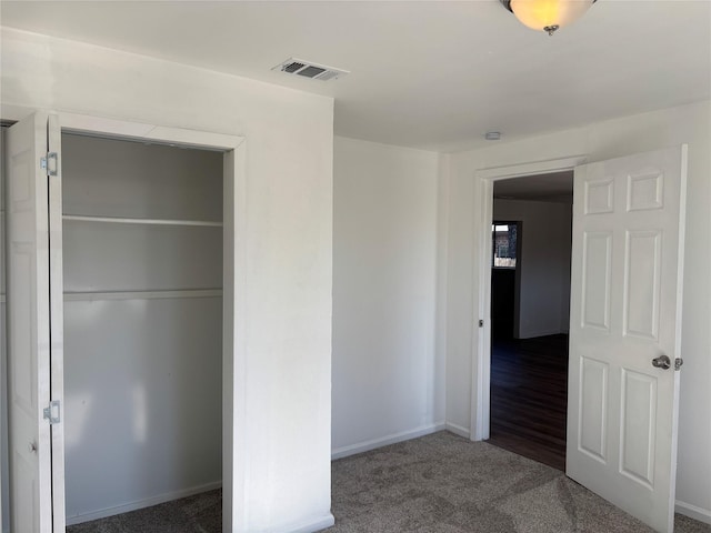 unfurnished bedroom featuring a closet and carpet flooring