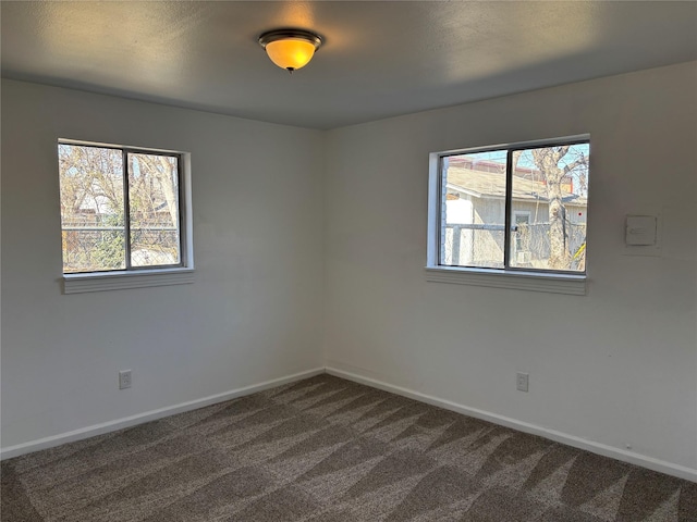 spare room featuring a healthy amount of sunlight and carpet floors