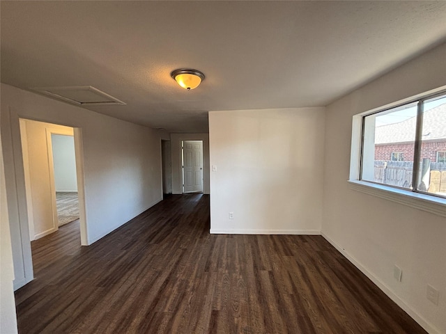 spare room with dark wood-type flooring