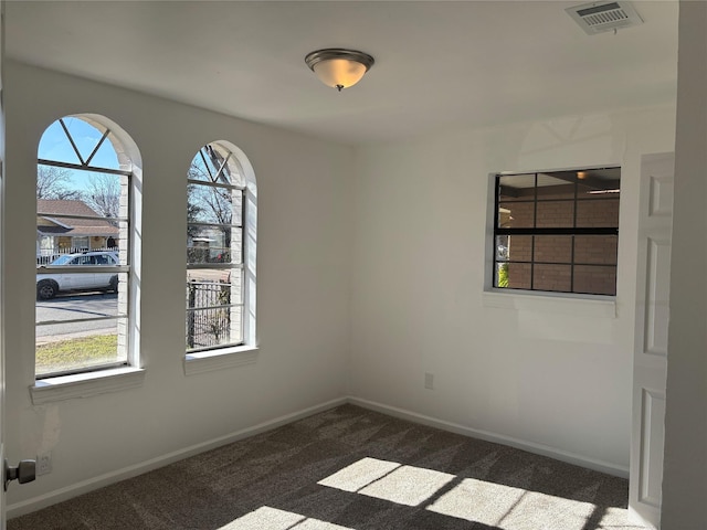 empty room featuring dark colored carpet