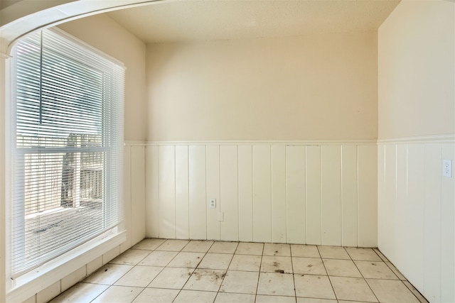 tiled empty room with a wealth of natural light