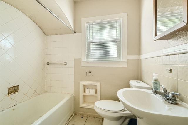 bathroom with toilet, tile patterned floors, sink, and a bathing tub