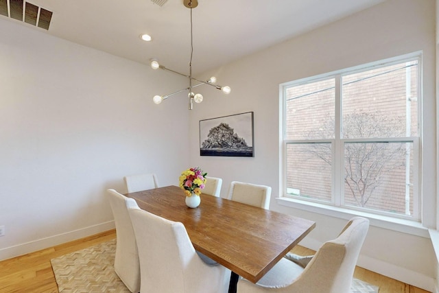 dining space with light hardwood / wood-style flooring