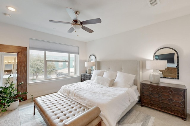 bedroom with ceiling fan and light colored carpet