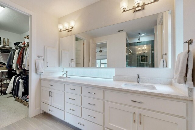 bathroom featuring ceiling fan, vanity, tile patterned floors, and a shower with door