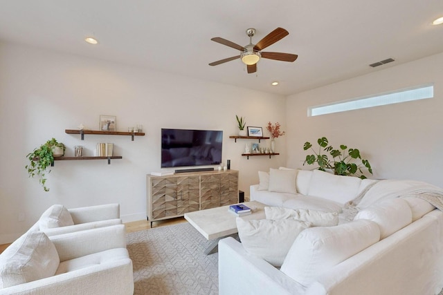 living room with ceiling fan and hardwood / wood-style flooring