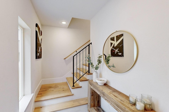 staircase featuring recessed lighting, baseboards, and wood finished floors