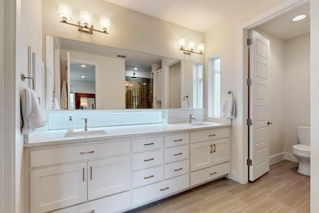 bathroom featuring toilet and vanity