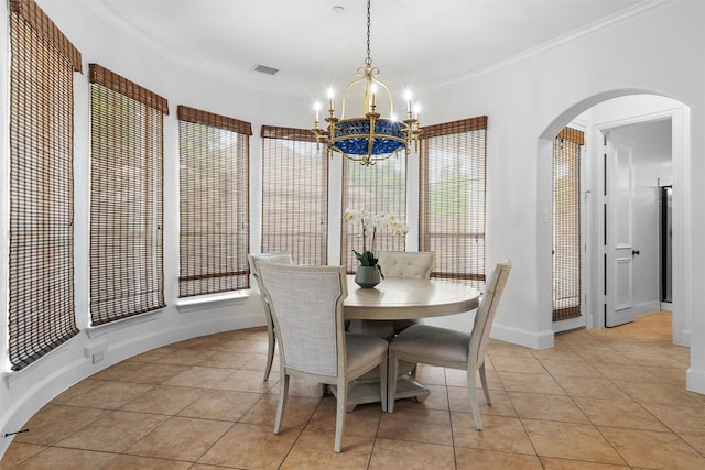 tiled dining room featuring ornamental molding and a notable chandelier