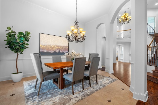 tiled dining area featuring ornamental molding, stairway, arched walkways, an inviting chandelier, and baseboards