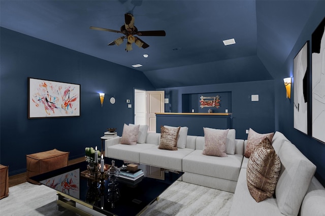 cinema featuring wood finished floors, a ceiling fan, and vaulted ceiling