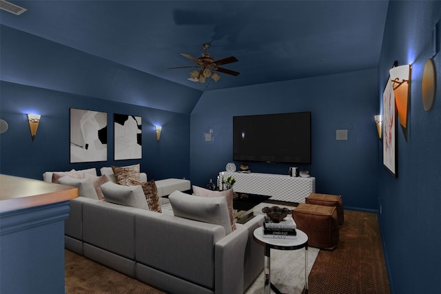 home theater room featuring lofted ceiling, a ceiling fan, visible vents, and carpet floors