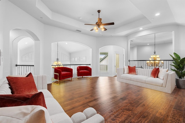 living room featuring visible vents, ceiling fan with notable chandelier, hardwood / wood-style flooring, recessed lighting, and a raised ceiling