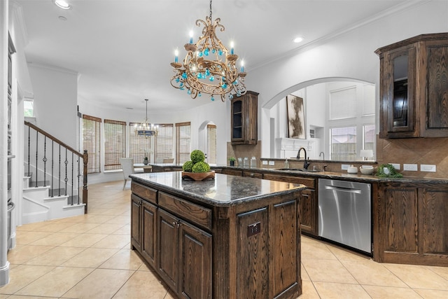 kitchen featuring a notable chandelier, a sink, stainless steel dishwasher, arched walkways, and light tile patterned flooring