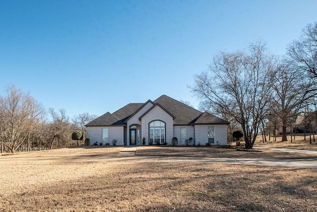 french country style house with a front yard