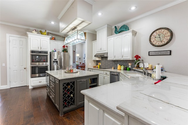 kitchen featuring sink, white cabinetry, light stone counters, ornamental molding, and stainless steel appliances