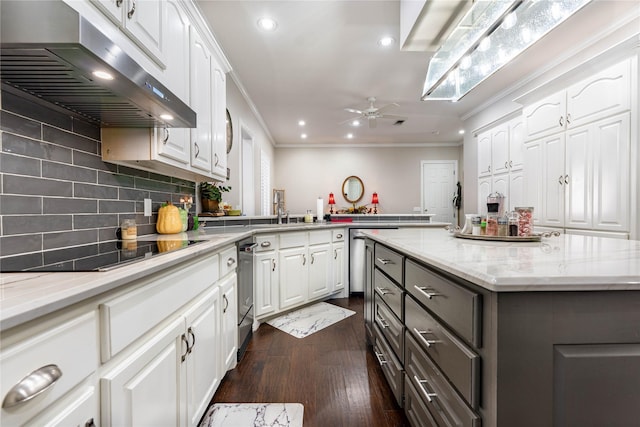 kitchen with a center island, dark brown cabinetry, black electric stovetop, ornamental molding, and white cabinets