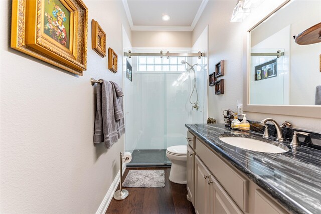 bathroom with hardwood / wood-style flooring, vanity, an enclosed shower, ornamental molding, and toilet