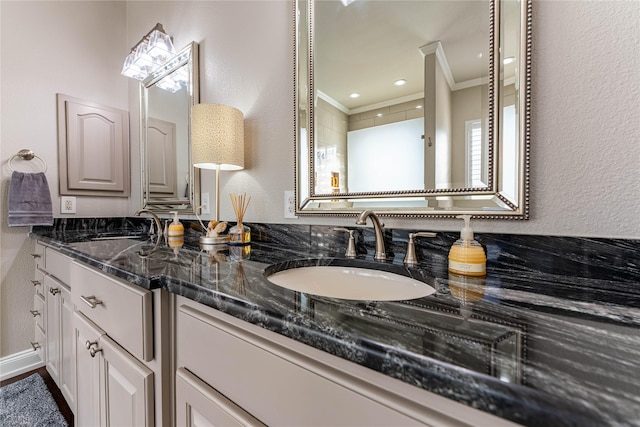 bathroom with vanity and ornamental molding