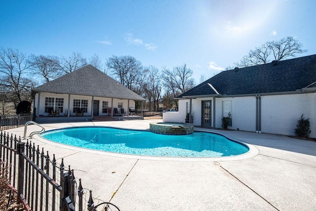 view of pool featuring an in ground hot tub, an outdoor structure, and a patio