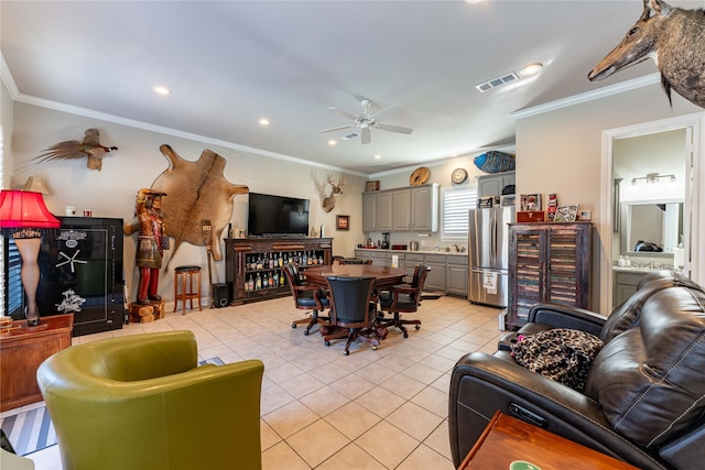 living room featuring light tile patterned flooring, ceiling fan, and crown molding