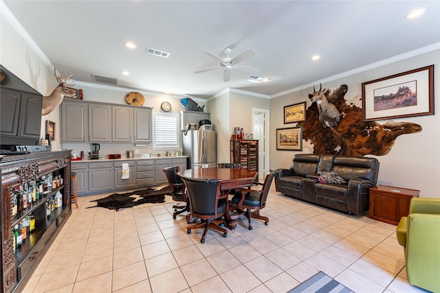 dining area with light tile patterned floors, ornamental molding, and ceiling fan