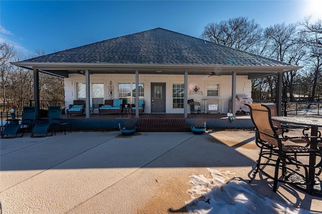 rear view of property featuring a patio area and a porch