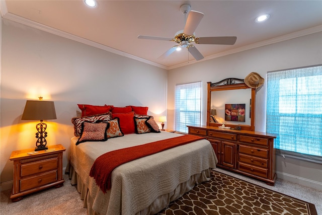 carpeted bedroom with ornamental molding and ceiling fan