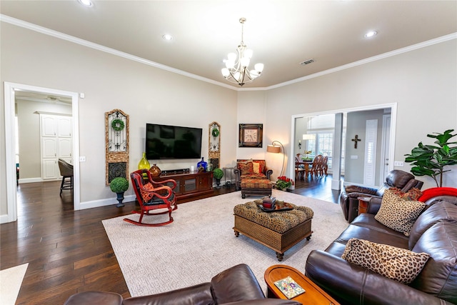 living room with ornamental molding, dark wood-type flooring, and a notable chandelier