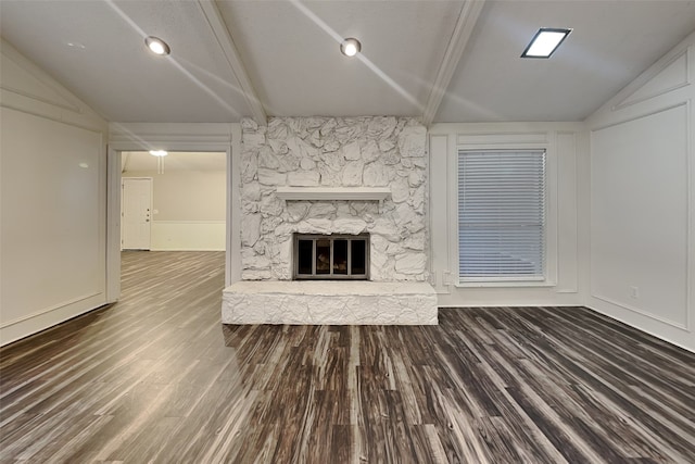 unfurnished living room with lofted ceiling, a fireplace, and dark hardwood / wood-style floors