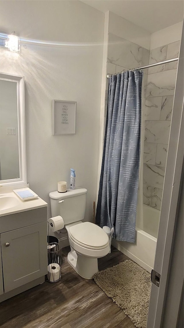 full bathroom with toilet, vanity, wood-type flooring, and shower / bath combination with curtain