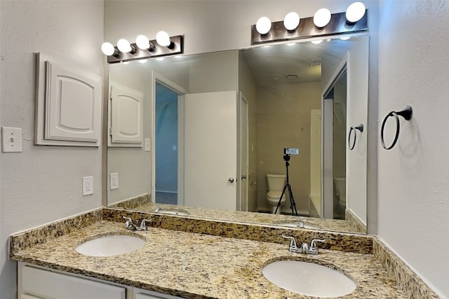 bathroom with toilet and vanity