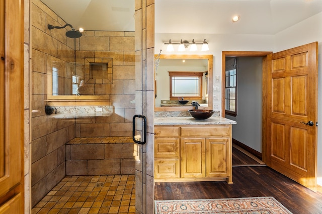 bathroom with an enclosed shower, vanity, and hardwood / wood-style floors