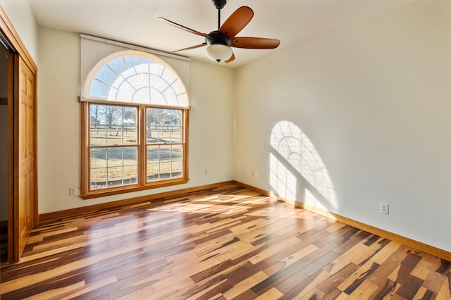 spare room with light wood-type flooring and ceiling fan