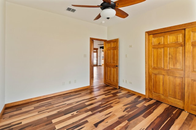 unfurnished bedroom featuring hardwood / wood-style flooring and ceiling fan