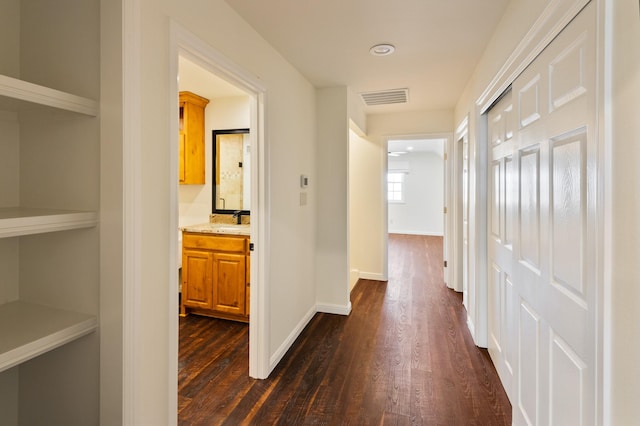 hallway with sink and dark hardwood / wood-style floors