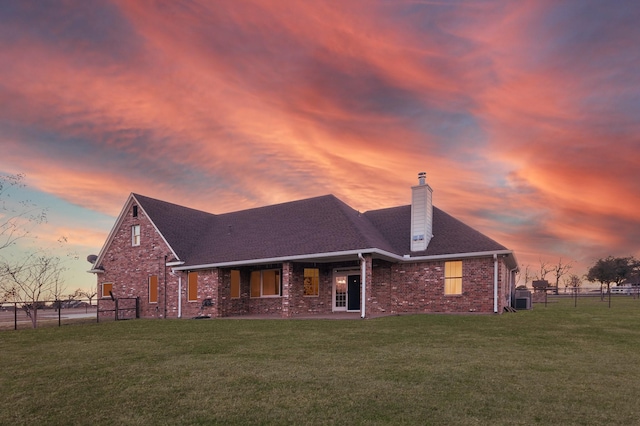 back house at dusk with a yard