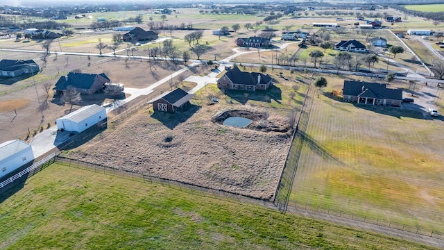 birds eye view of property with a rural view