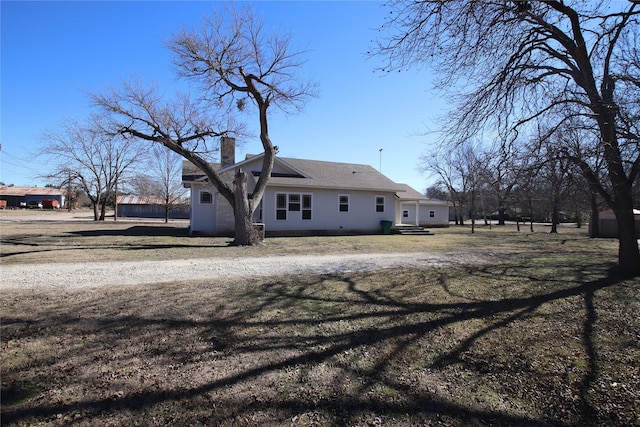 rear view of house with a yard