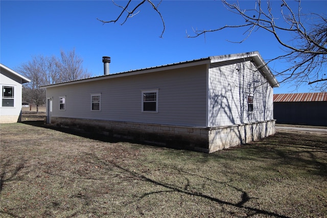 view of property exterior featuring a lawn