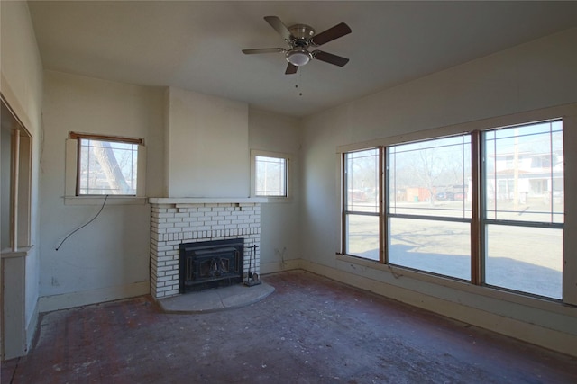 unfurnished living room with ceiling fan, plenty of natural light, and a fireplace