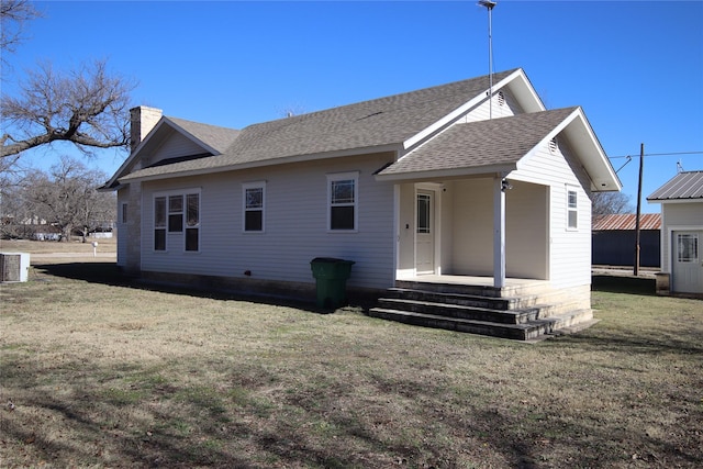 back of house featuring a yard and central air condition unit