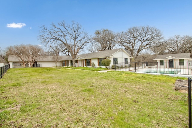 exterior space with a yard, fence, and a fenced in pool