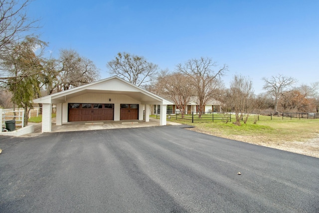 exterior space featuring an outdoor structure, fence, and a garage