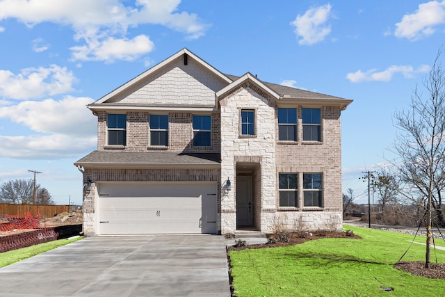 view of front facade with a shingled roof, concrete driveway, a front yard, a garage, and stone siding