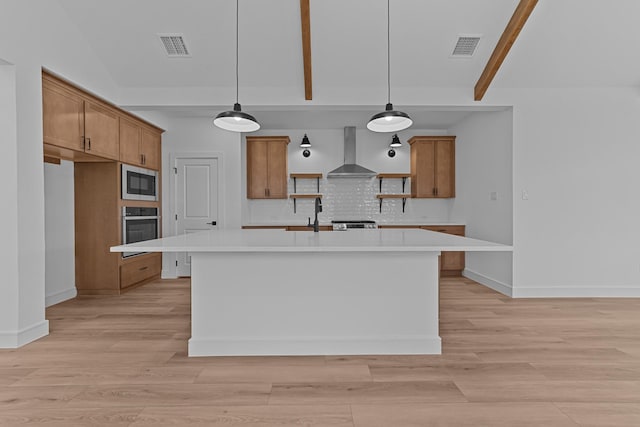 kitchen featuring appliances with stainless steel finishes, brown cabinetry, wall chimney range hood, and open shelves