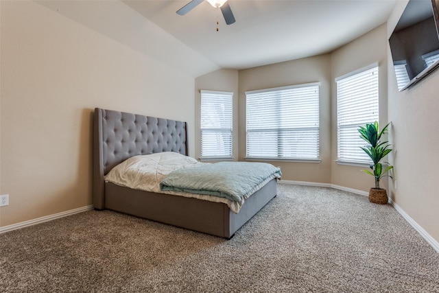 carpeted bedroom featuring ceiling fan and vaulted ceiling