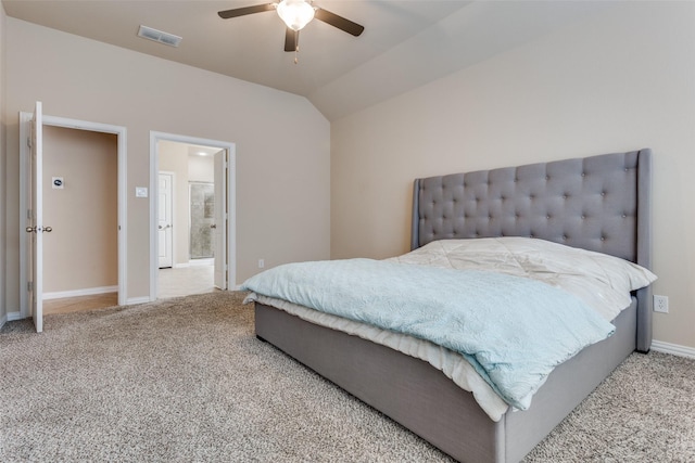 carpeted bedroom featuring ceiling fan, ensuite bath, and vaulted ceiling