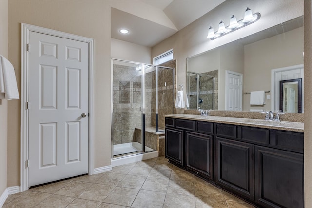 bathroom featuring vanity, a shower with shower door, vaulted ceiling, and tile patterned flooring